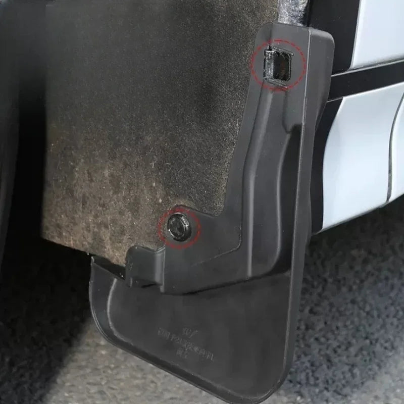 Detailed view of a durable black plastic car mudguard with secure fastening points.