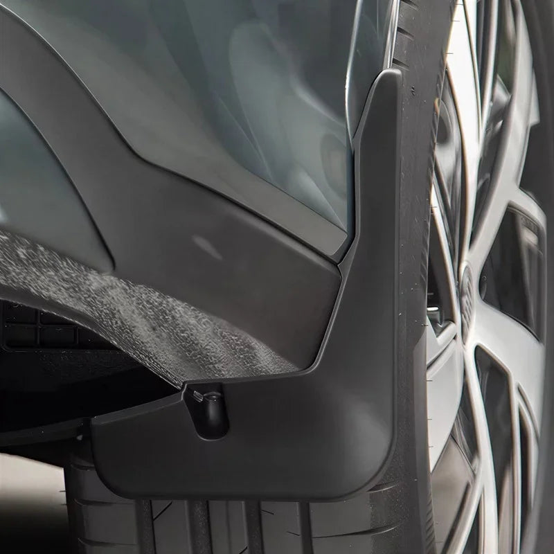 Durable matte black thermoplastic mud flap installed on a vehicle wheel arch for protection.