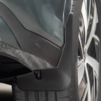 Durable matte black thermoplastic mud flap installed on a vehicle wheel arch for protection.