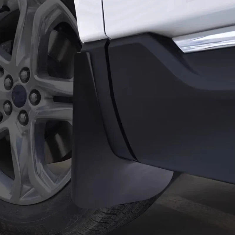 Matte black durable rubber mud flap installed behind the wheel for vehicle protection.