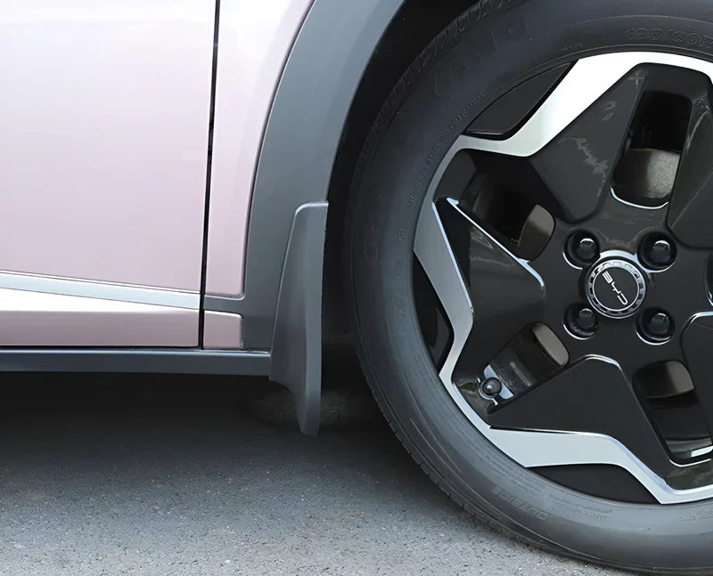 Durable matte grey plastic mud flap installed on a pink BYD vehicle wheel arch.