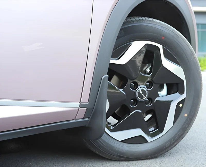 Black durable rubber mud flap installed on a pink BYD car wheel arch for protection.