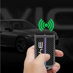 Black carbon fiber texture smart key fob with red and blue racing stripes.