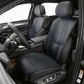 Professional black leather car seat covers with vertical stitching and ergonomic design.