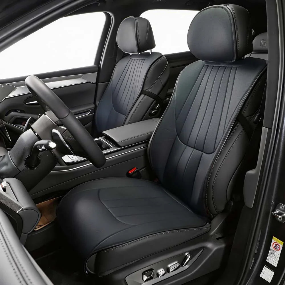 Professional black leather car seat covers with vertical stitching and ergonomic design.