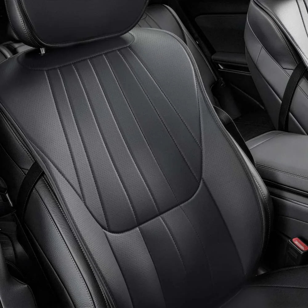 Close-up of premium black perforated leather car seat with elegant vertical stitching.