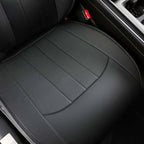 Close-up of perforated black leather car seat cover with precise stitching.