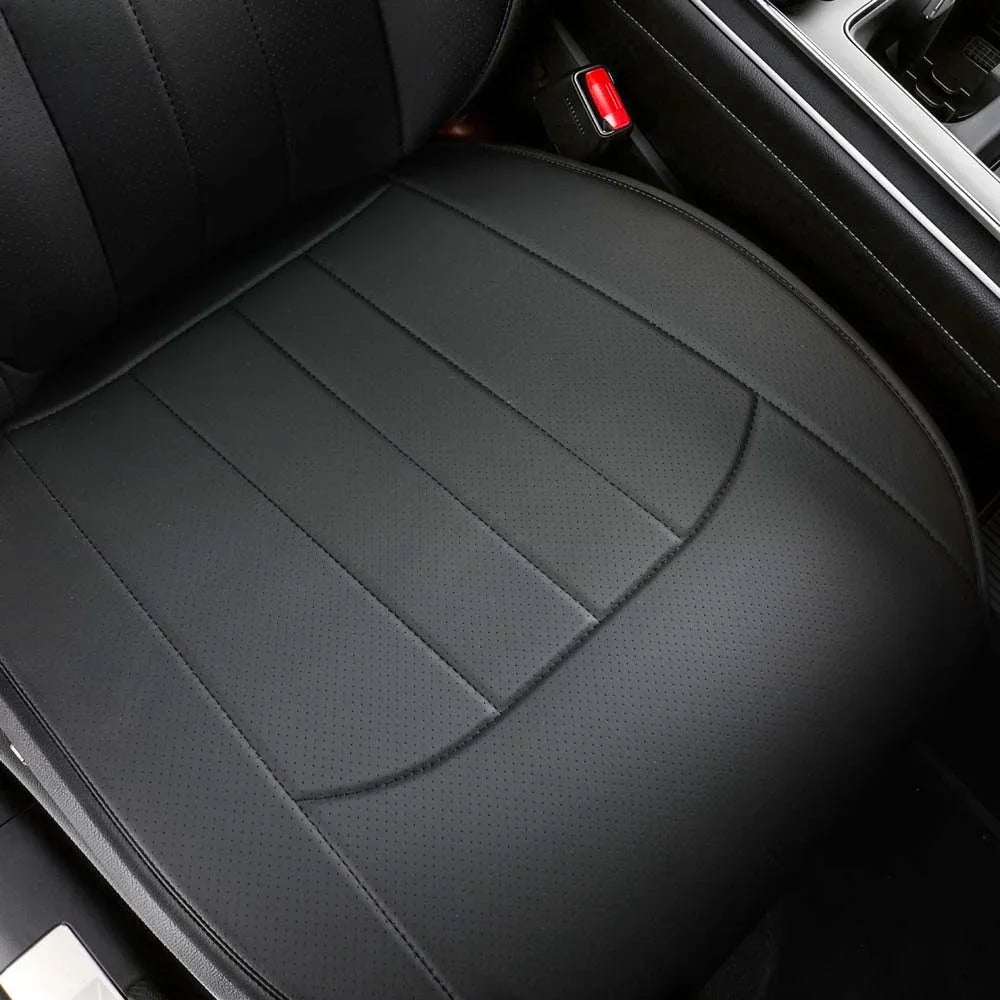 Close-up of perforated black leather car seat cover with precise stitching.