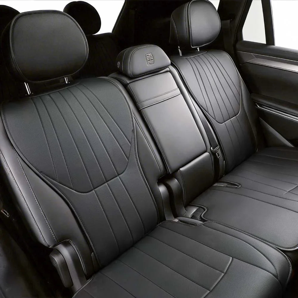 Professional black leather car seat covers with elegant ribbed stitching for interior protection.