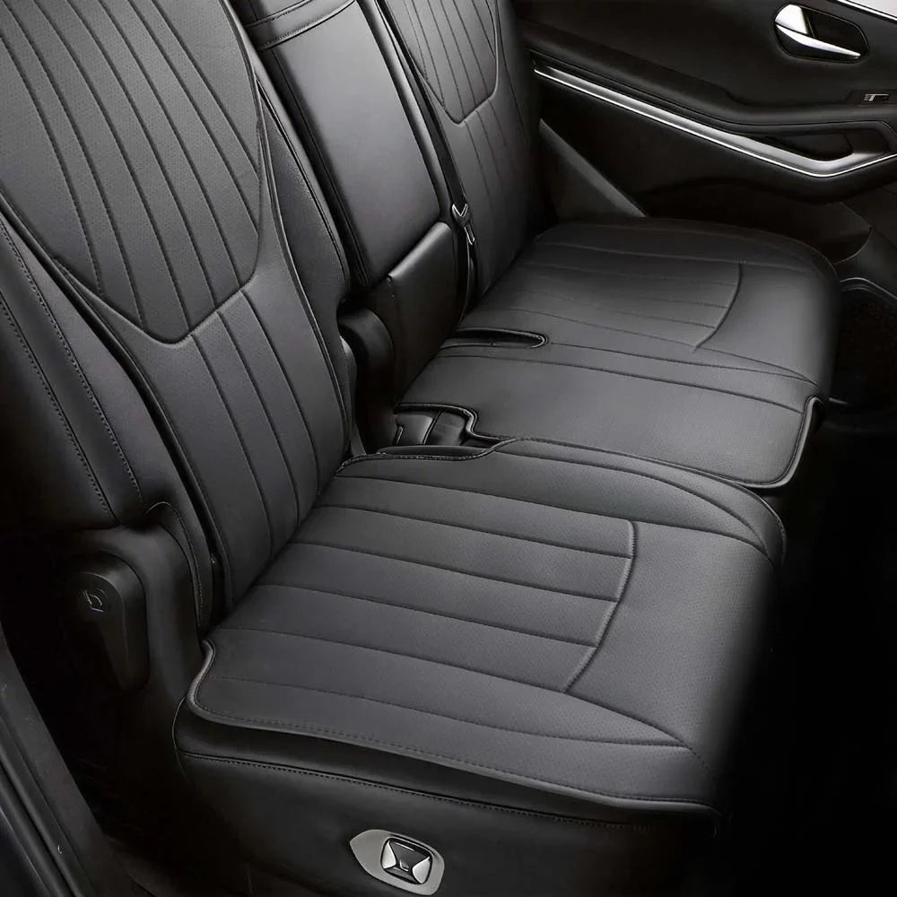 Premium black synthetic leather rear car seat covers with perforated quilted stitching.