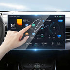 A hand interacting with a high-definition digital touchscreen infotainment system in a car interior.