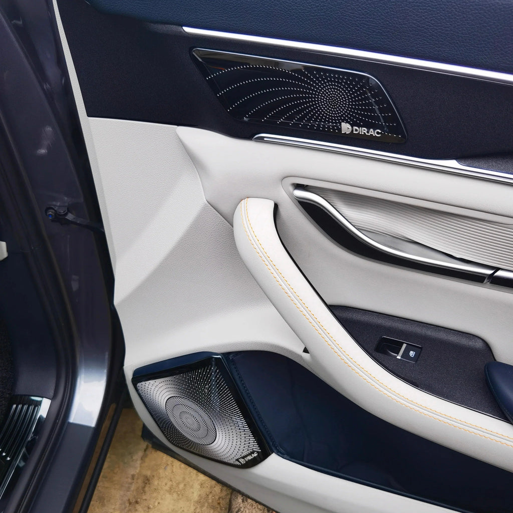 Premium white and navy blue leather car door panel with Dirac audio speaker and chrome trim.