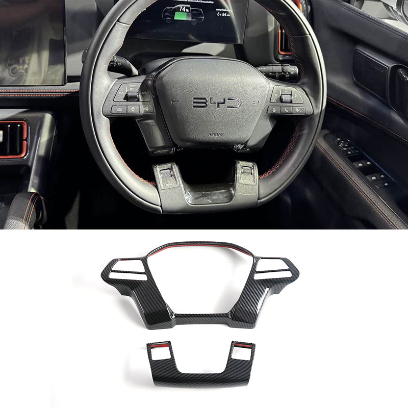Carbon fiber interior trim accessories with red accents for BYD steering wheel.