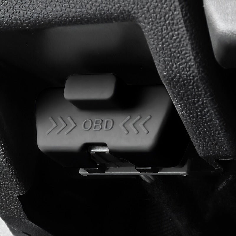 Close-up of a professional black plastic OBD port cover with embossed lettering.