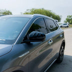 Grey BYD SUV featuring premium dark tinted windows and sleek black side mirrors.