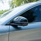 Sleek silver car side mirror with integrated LED indicator and glossy black finish.