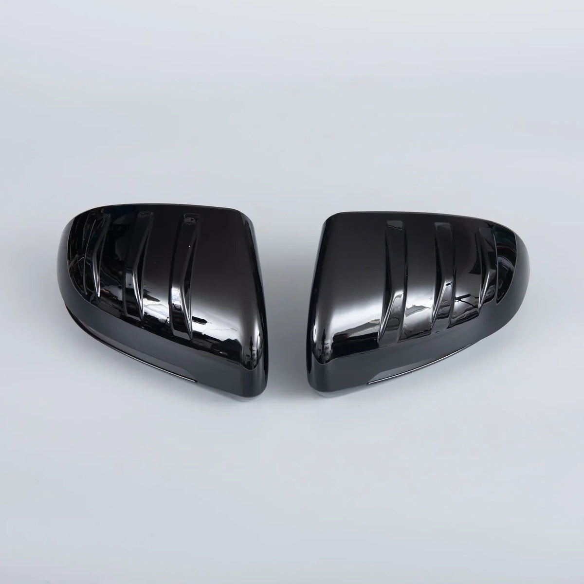 Pair of sleek, glossy black aerodynamic side mirror covers for BYD vehicles.