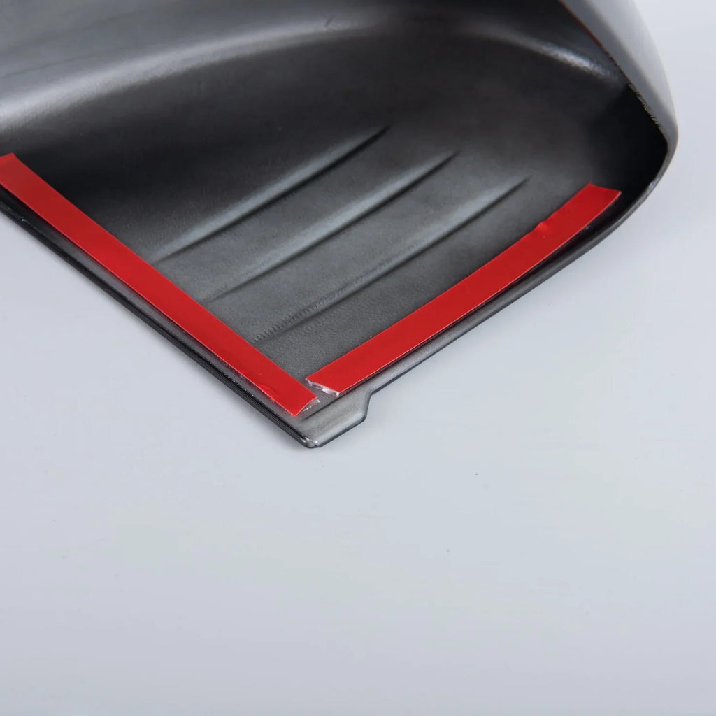 Black textured car mud flap featuring a vibrant red protective edge strip.