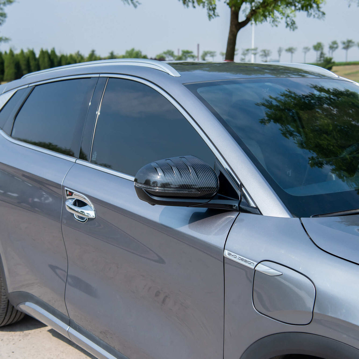 Carbon fiber texture side mirror cover in black for a silver BYD vehicle