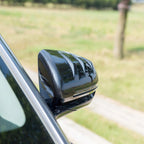 Glossy black carbon fiber side mirror cover for BYD car, showcasing a premium textured finish.