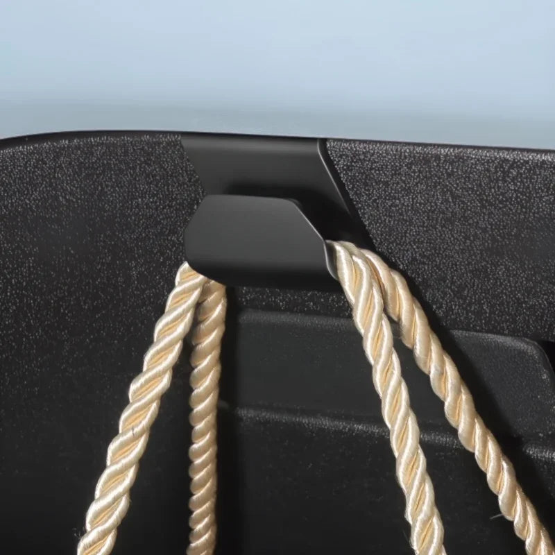 Premium black textured material with elegant cream-colored twisted rope accents.