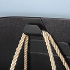 Premium black textured material with elegant cream-colored twisted rope accents.