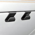 Two matte black durable plastic seat back hooks mounted on a white leather car interior.