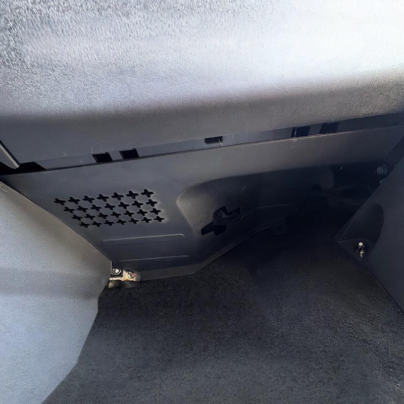 Close-up of a durable black textured plastic car interior panel with ventilation slots.