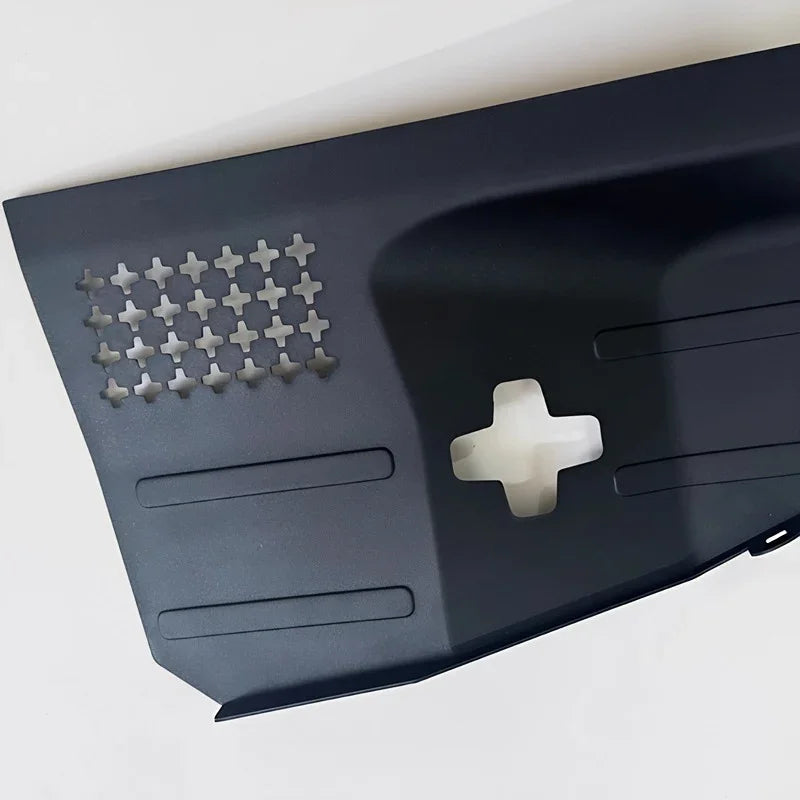 Matte black durable plastic car accessory panel with cross-shaped cutout and ventilation grid.