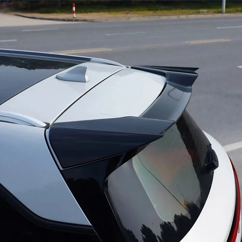 Glossy black rear roof spoiler accessory installed on a white BYD vehicle