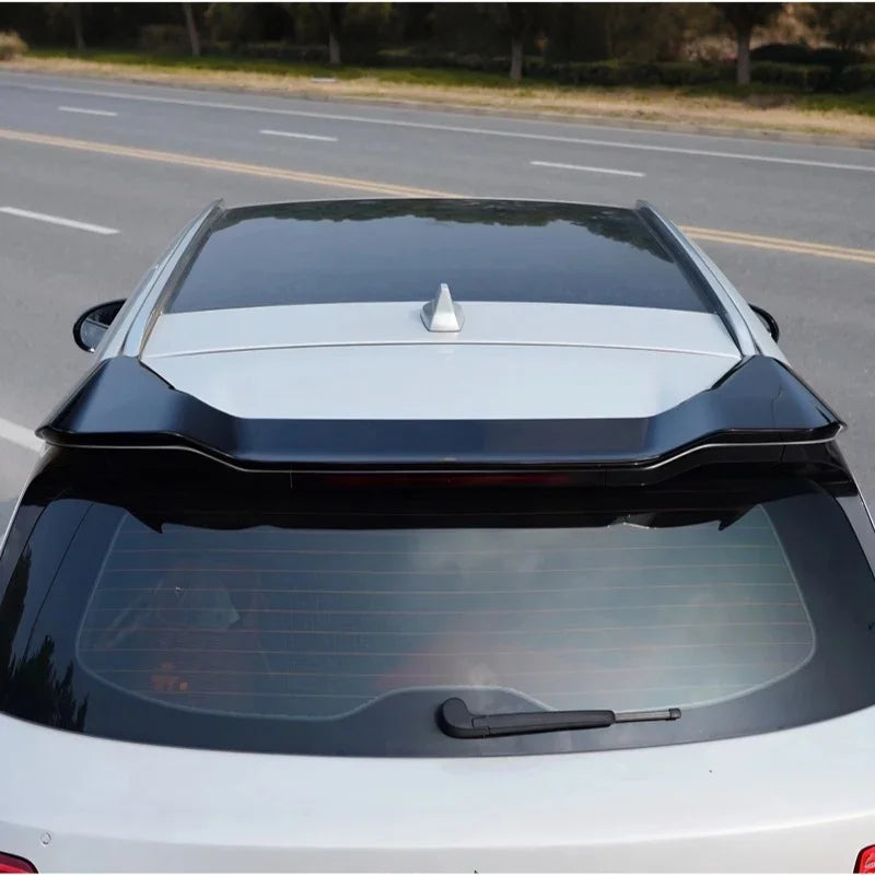 Glossy black rear roof spoiler installed on a silver car for a sporty, aerodynamic look.