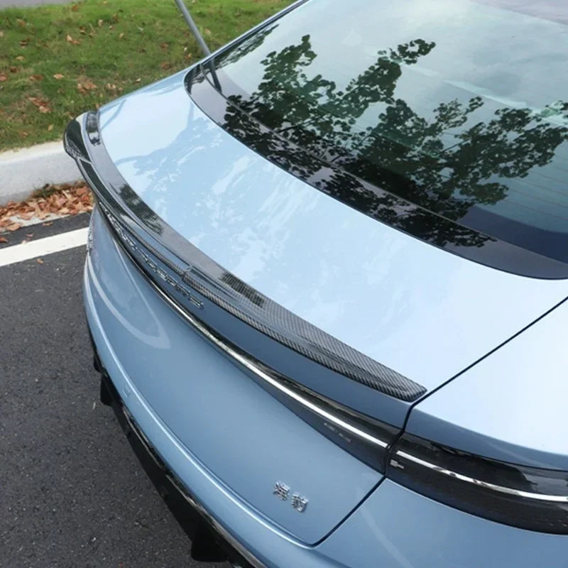 Carbon fiber texture rear spoiler for BYD, sleek black finish for enhanced aerodynamics.