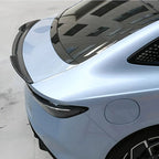 Carbon fiber rear spoiler installed on a light blue BYD car for enhanced aerodynamics.