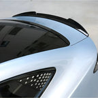 Glossy black rear spoiler installed on a sleek white BYD car for enhanced aerodynamics.