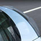Carbon fiber rear spoiler installed on a light blue BYD car.