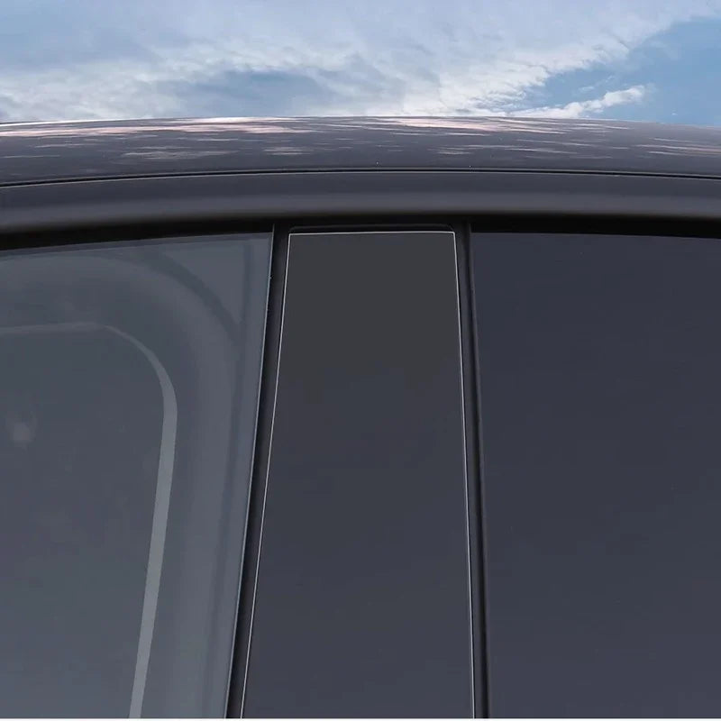 Sleek black tinted window deflectors installed on a car door for enhanced aerodynamics and style.