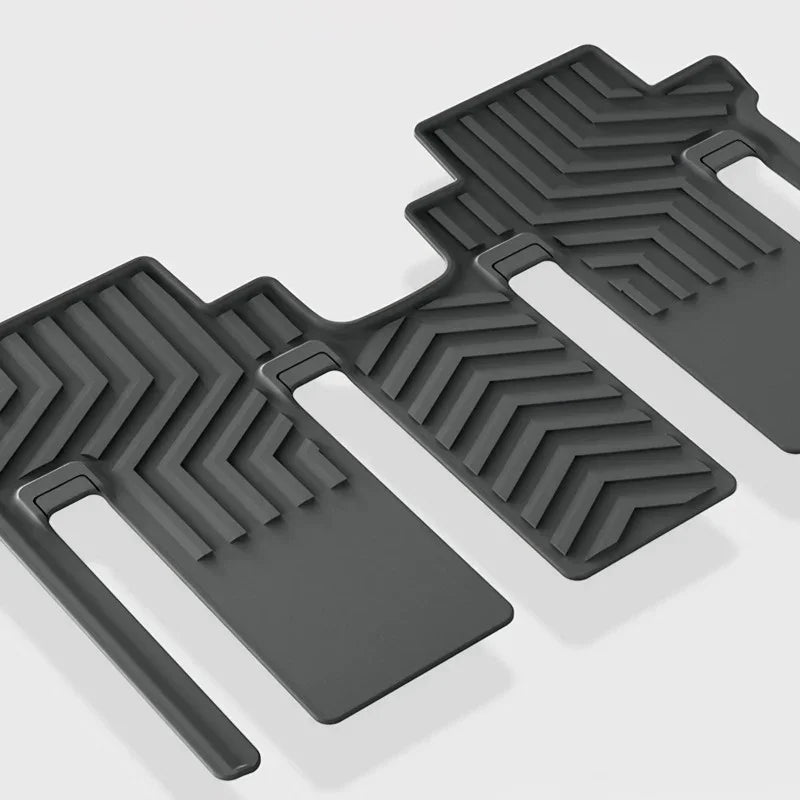 Black heavy-duty rubber car floor mats with anti-slip chevron pattern texture.