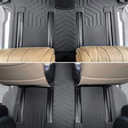 Black TPE custom-fit floor mats with textured pattern paired with beige leather car seats.