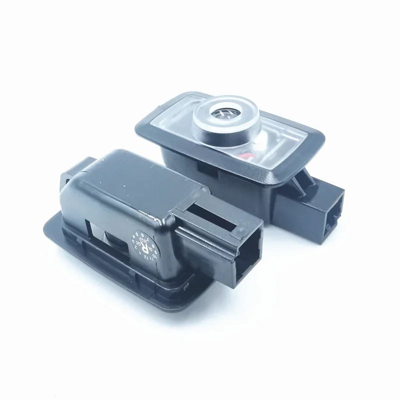 Pair of black durable plastic automotive sensors with silver metallic circular components.
