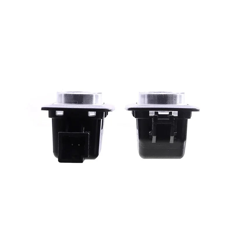 Pair of durable black plastic automotive electrical switch components on a white background.