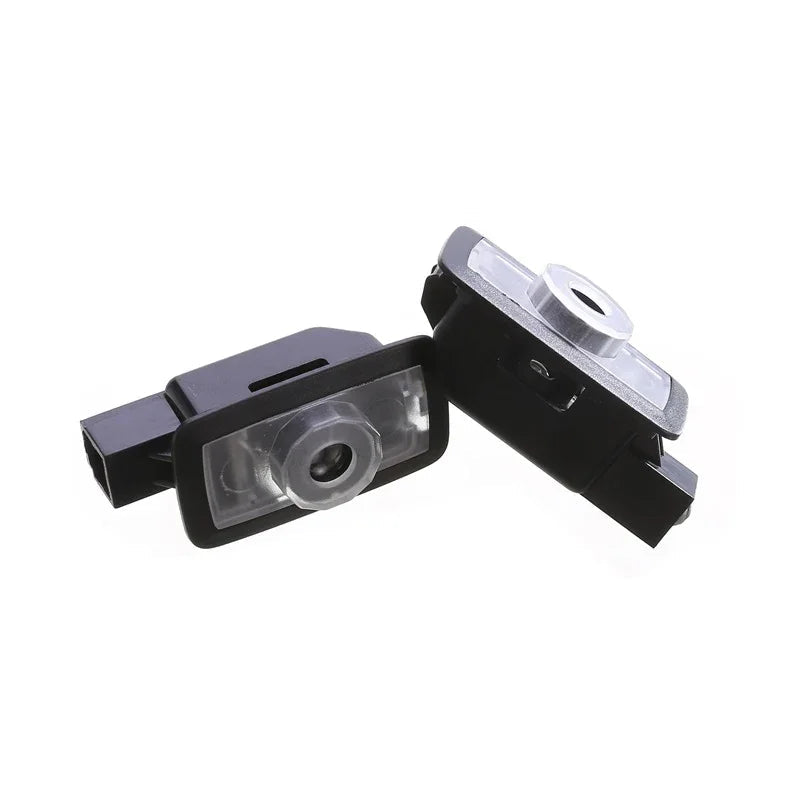 Pair of black matte plastic and silver metallic car door hinge pins.