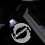 White LED puddle light projecting the DENZA logo onto a dark car door sill.