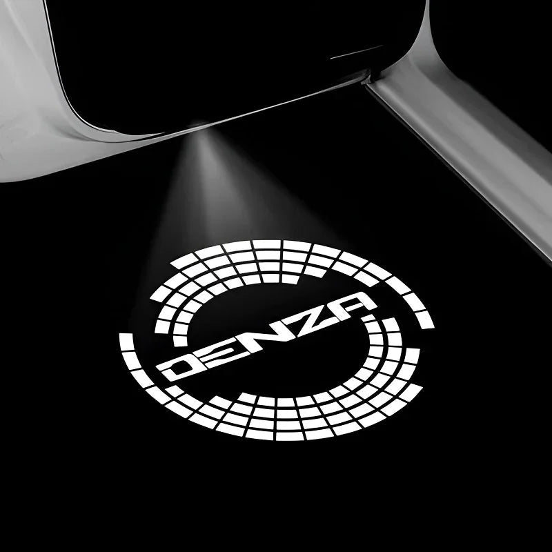 Illuminated white DENZA logo projected onto a black car floor mat surface.