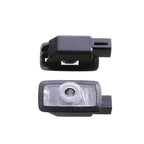 Two black plastic car accessories with clear lens components, professional automotive grade.