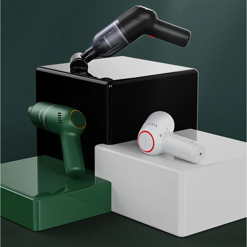 Set of three portable handheld car vacuum cleaners in black, forest green, and white matte finishes.
