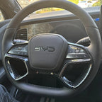 Black leather steering wheel with carbon fiber trim and BYD logo for BYD car interior.