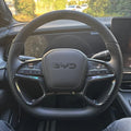 Black leather and carbon fiber steering wheel with BYD logo for premium car interior upgrade.