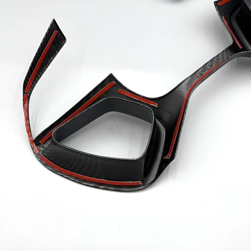 Black carbon fiber interior trim piece with striking red accent edges for BYD accessories.