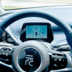 Digital instrument cluster display showing speed and battery status in a modern BYD interior.