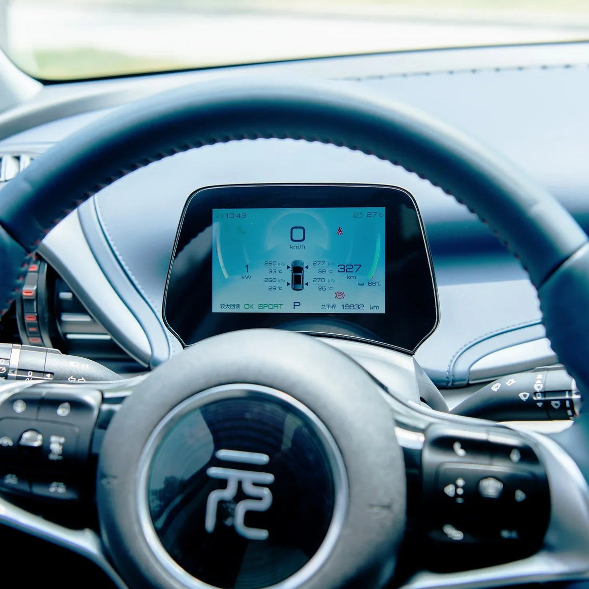 Digital instrument cluster display showing speed and battery status in a modern BYD interior.